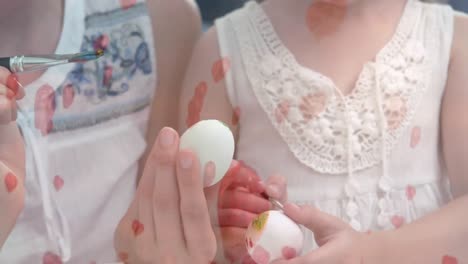 mother and daughter painting easter eggs