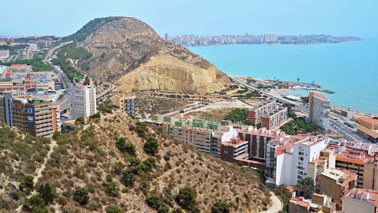 View of city and a mountain near sea shoreline in Alicante, Spain
