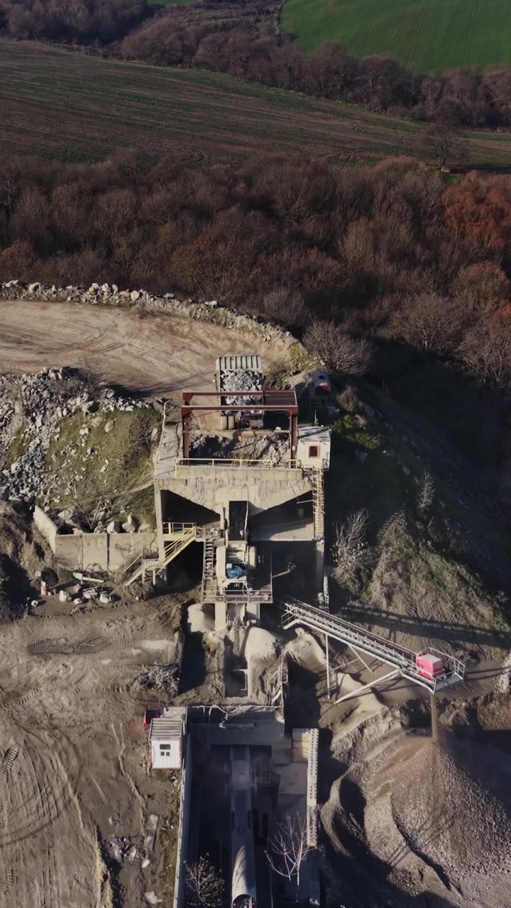 Quarry site showing mining activity and equipment at work in open area