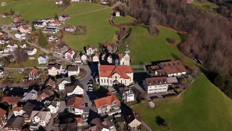 aerial of landmark church in quaint swiss village - rieden, switzerland