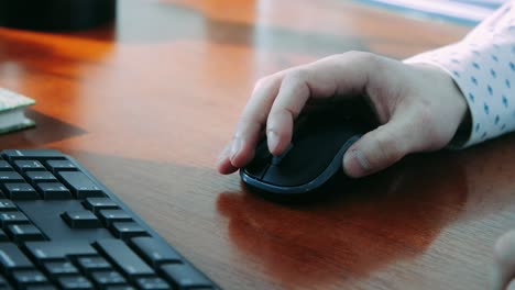 man using computer mouse during work. office worker controlling computer