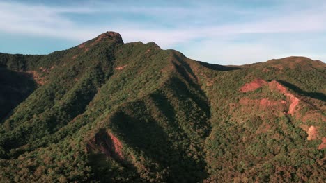 Scenic-Ma-On-Shan-mountains,-wispy-clouds,-blue-sky,-aerial-pan