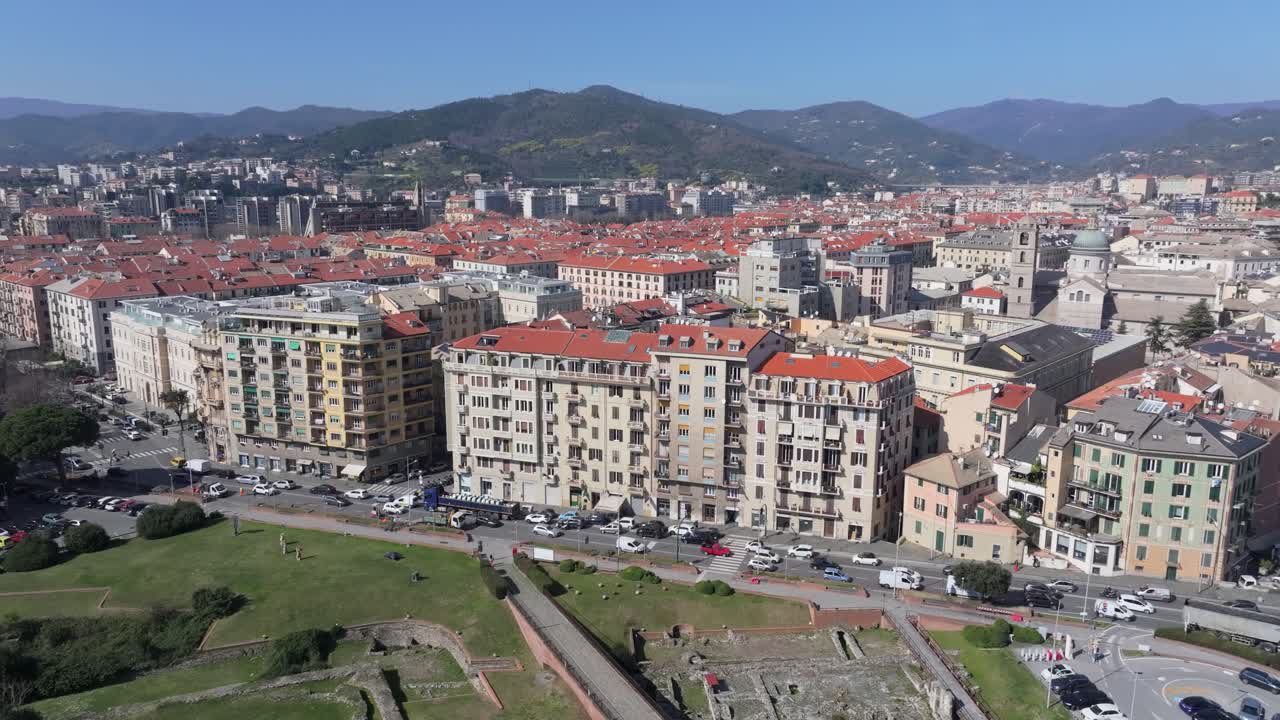 Historic Priamar Fortress overlooks sunny Savona cityscape and distant mountains