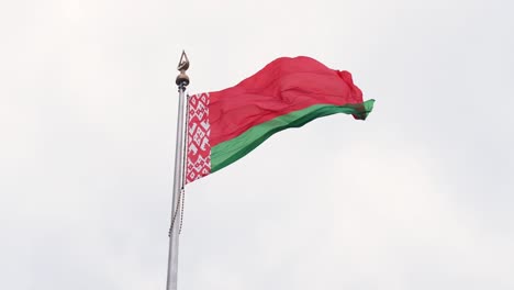 the flag of the republic of belarus flutters in the wind