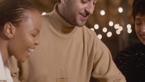 group of happy multiethnic friends celebrating new year countdown together and toasting with champagne glasses 1