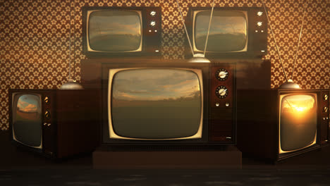 An-exhibition-of-old-fashioned-retro-color-tv-sets-with-antennas.-Electronic-devices-stack-in-front-of-vintage-wallpaper.-Obsolete-television-is-displaying-a-green-screen.