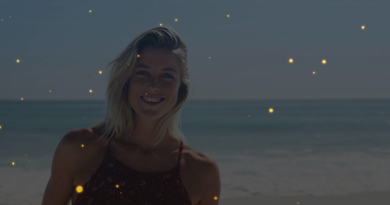 Woman posing on shore, gold particles drifting, sunlight rising revealing face for marketing