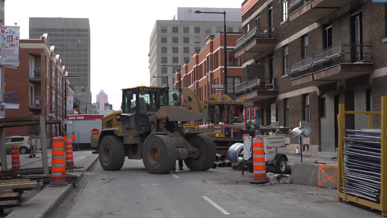 You can see an excavator that is halted in a construction site in Montreal.