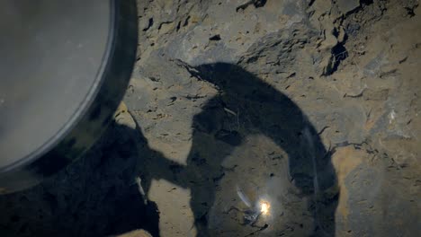 loupe, burning moss with a magnifying glass on a stone