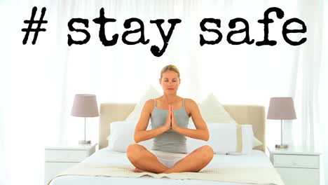 animación de las palabras # mantenerse a salvo escrito sobre mujer practicando yoga en la cama en casa.