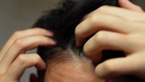 asian-man-straightens-his-hair-while-mirroring