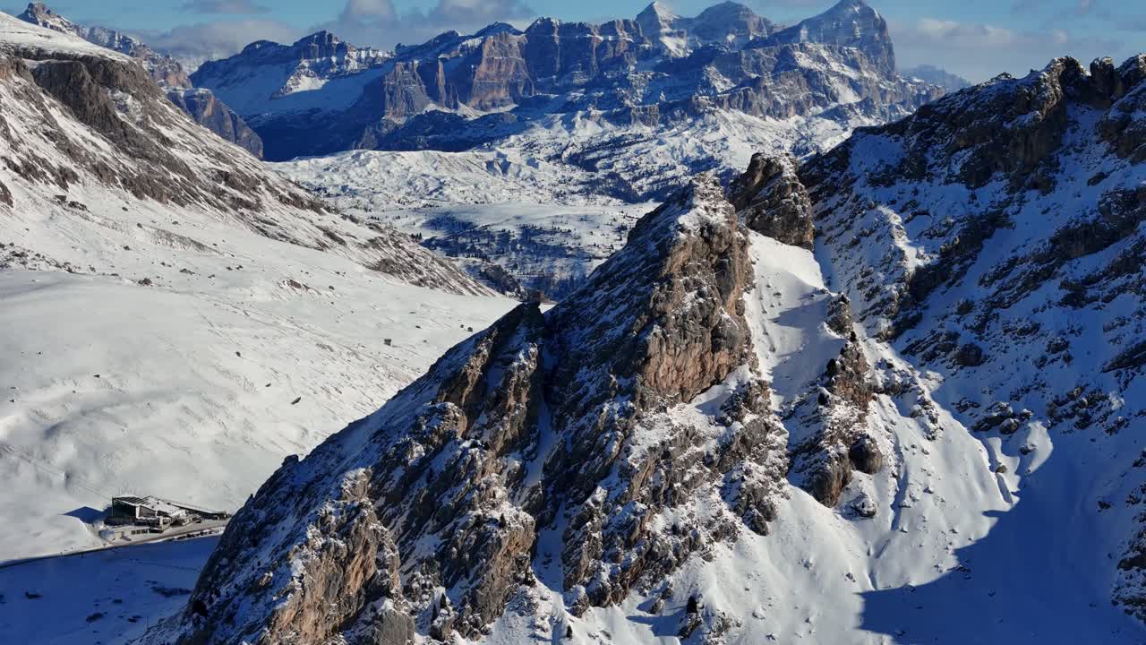 Reveal shot of Dolomites rock formation in the background during winter season (drone footage)