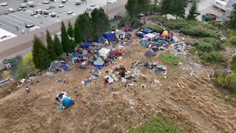 aerial shot of a homeless camp with tents and trash spread everywhere