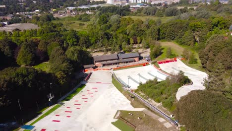 aerial pan shot of empty dry ski slope and lift in norwich, england