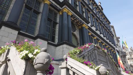 a historic city hall in ghent, belgium, with floral-decorated staircases in sunlight