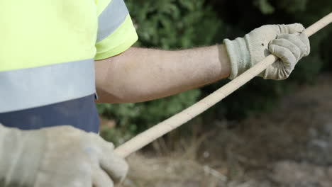 Contractor-holding-guiding-rope-pulling-heavy-industrial-equipment-close-up