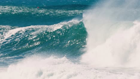 a lone surfer skillfully navigates through a massive wave, briefly vanishing within the powerful surf.