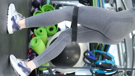 close up view of woman’s legs that doing fitness exercise indoors