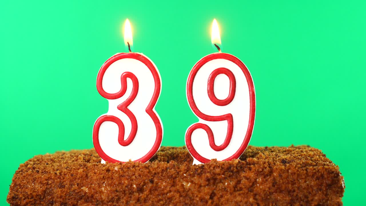 Cake with the number 39 lighted candle. Chroma key. Green Screen. Isolated