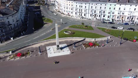 Seaside-town-Llandudno-giant-poppy-war-memorial-obelisk-gardens-idyllic-promenade-waterfront-aerial-view-orbit-right