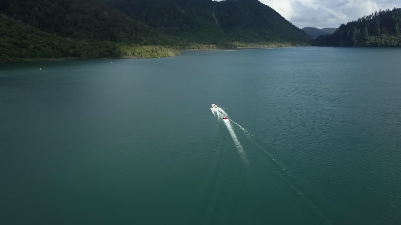 Waterskiing on a Lake Surrounded by Mountains