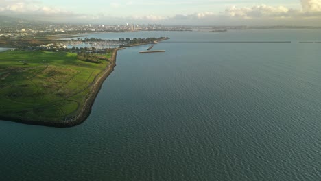 capturing the beauty of cesar chavez park, berkeley marina, and the expansive san francisco bay beneath a cloudy sky.