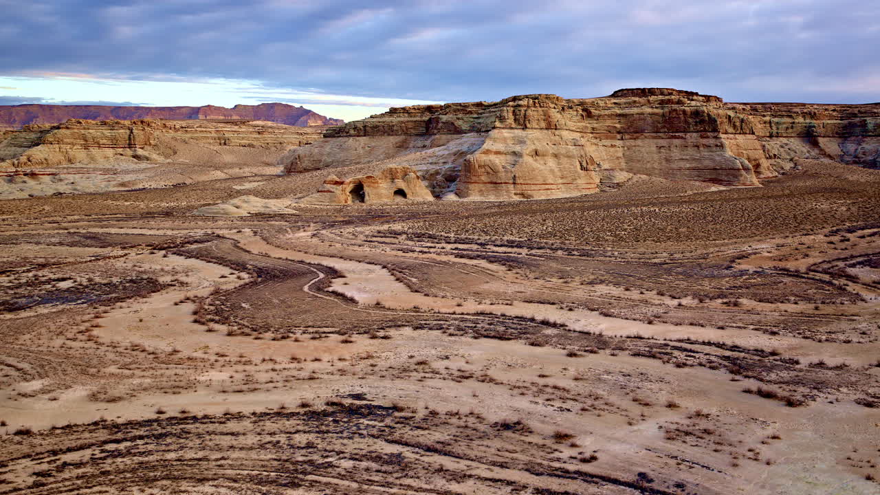 A sweeping drone shot emphasizing the vastness of the red rock desert near Lake Powell.