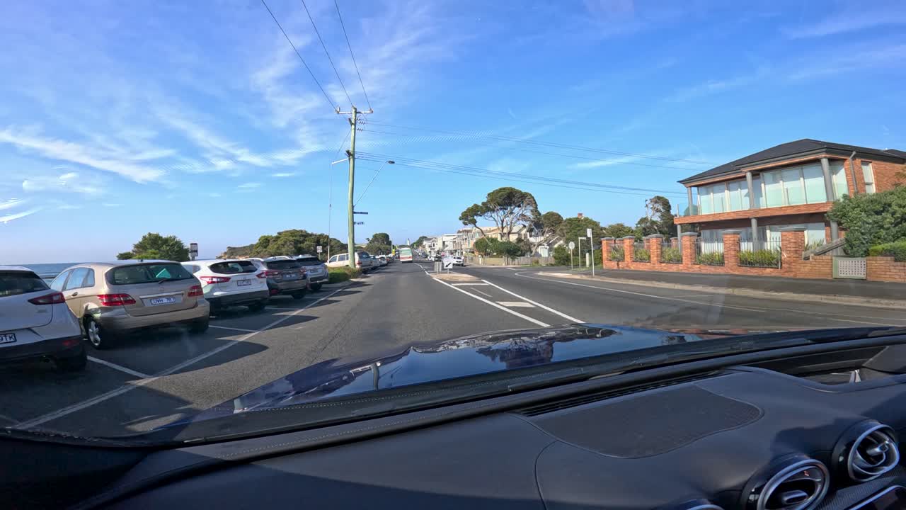 A car journey through Point Lonsdale, showcasing coastal roads, clear skies, and residential areas in bright daylight