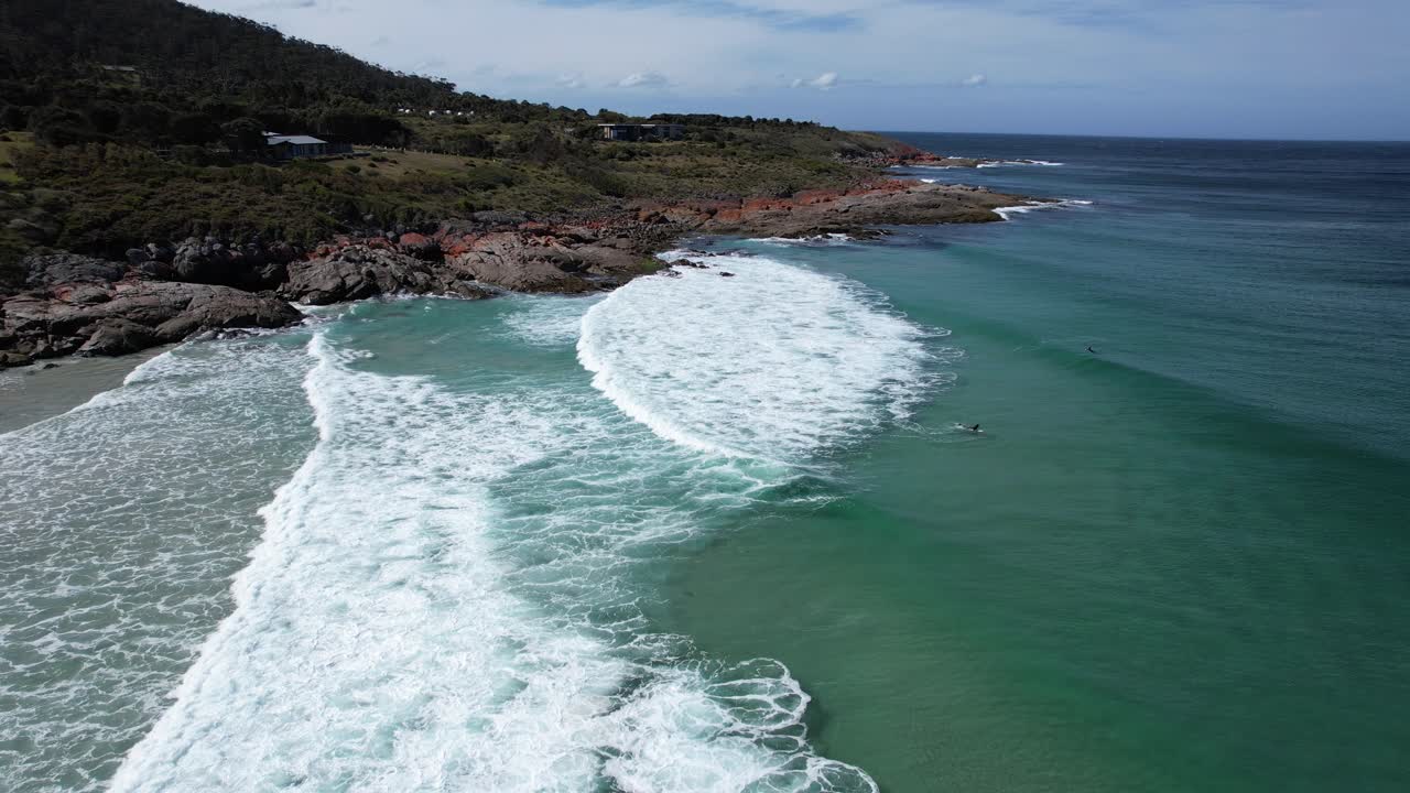 Surfers Riding The Waves At Little Beach Cove In Tasmania, Australia - Drone Shot