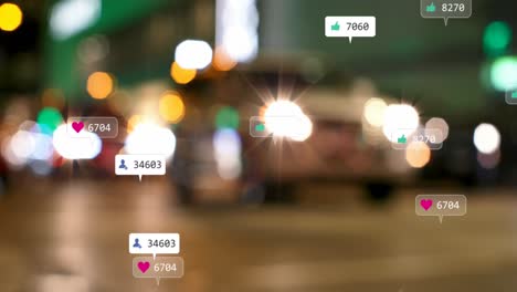 Animation-of-social-media-icons-and-numbers-over-out-of-focus-city-lights