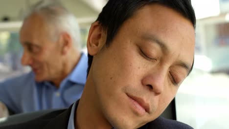 business commuter sleeping while travelling in bus 4k