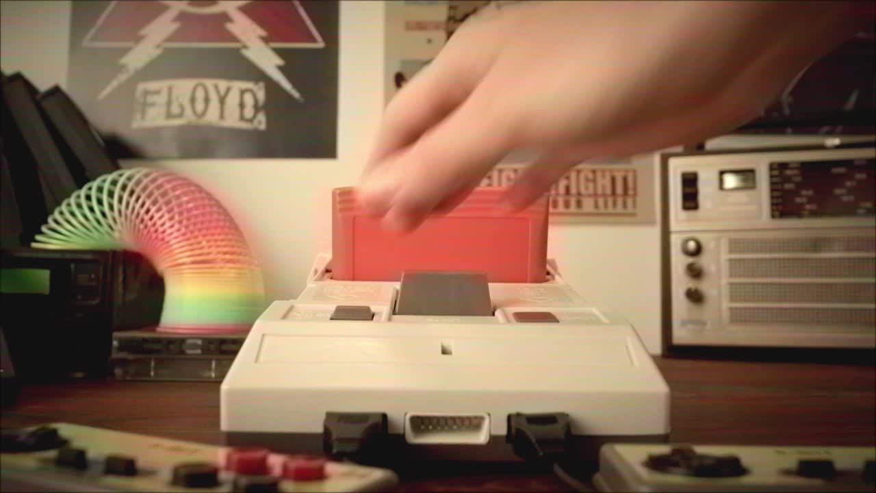 Inserting Game Cartridge into Retro Nintendo NES Console