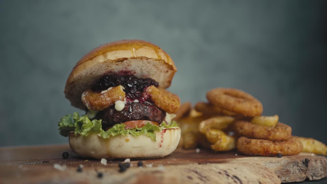 Delicious Burger with Onion Rings and Fries