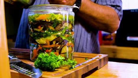 pickling liquid added to vegetables layered in glass jar