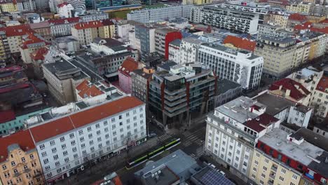 prague tram driving between houses and buildings in capital of czech republic