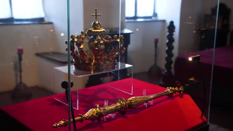 gold crown and scepter on display in museum