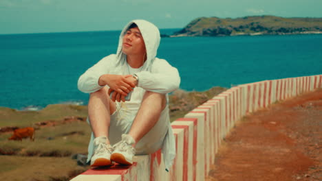 man relaxing by the ocean