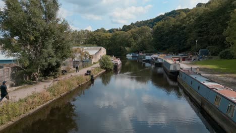 aerial footage of a canal with anglers fishing for roach and bream