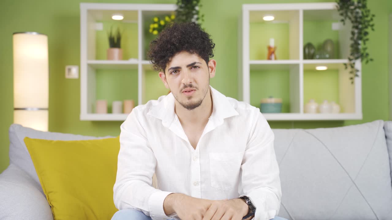 The young man who doesn't find the talk logical. Negative head movement.