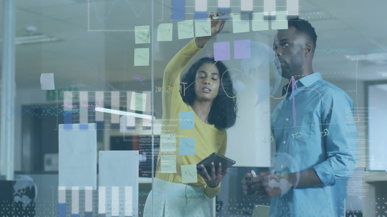 Collaborating on project, colleagues using digital graphs and sticky notes in office