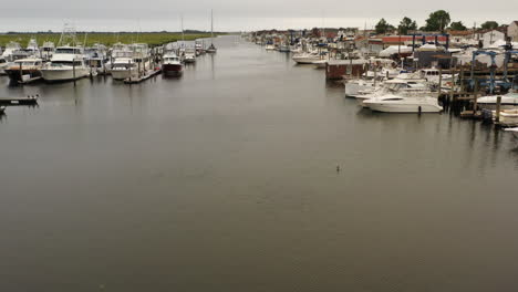 An-aerial-view-over-a-small-fishing-boat-sailing-by-Freeport,-NY