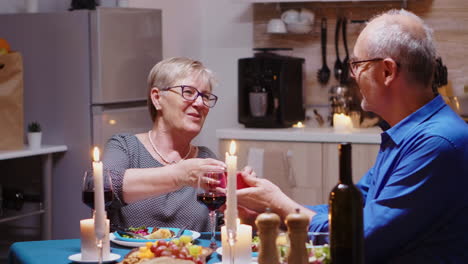 mature man surprising woman with gift