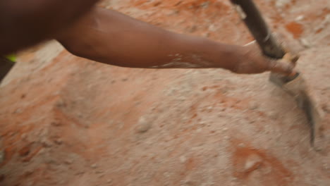 Close-up-of-worker-mixing-cement---soil-with-spade