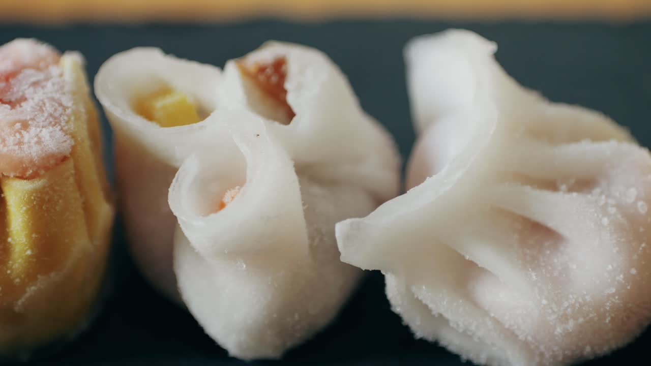 Various of frozen dim sum close-up macro. Food to take away. Chinese dessert food. Dimsum with shrimps, fish and meat. Dish in a cafe. Delivery