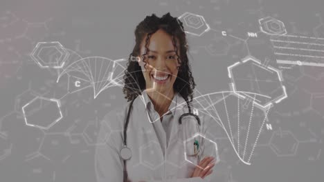 Animation-of-dna-strand-diagrams-with-data-processing-over-smiling-biracial-female-doctor