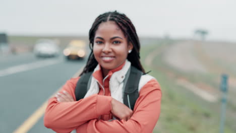 portrait of a smiling woman with backpack on a road