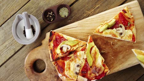 delicious pizza with ingredients on wooden table