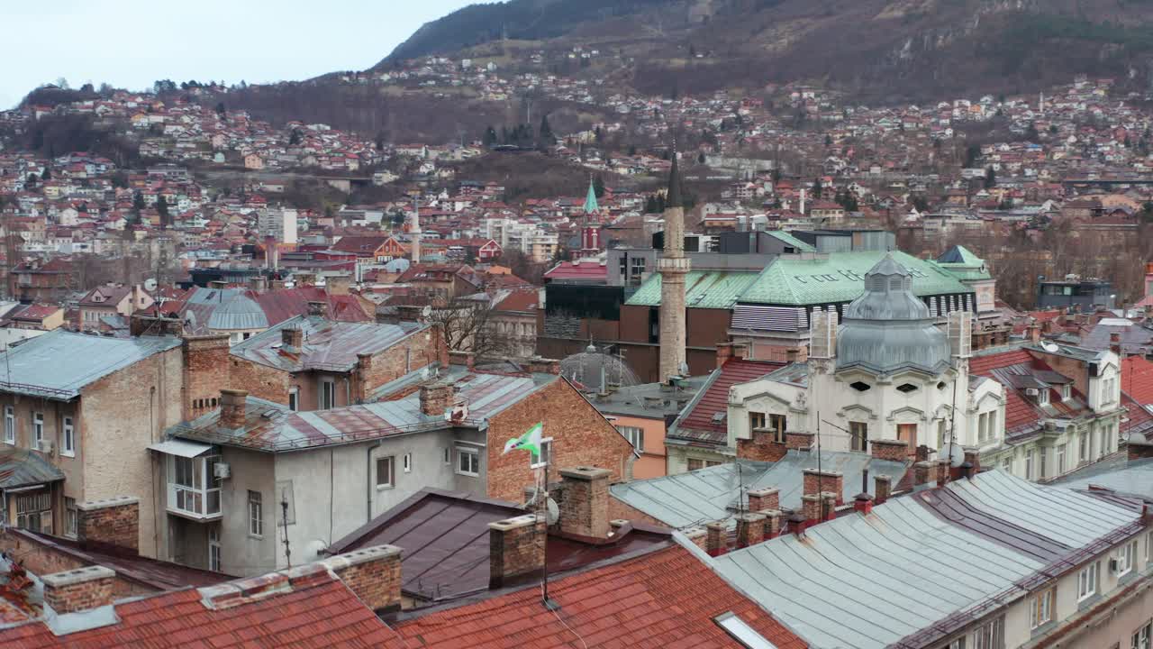 Aerial shot rising out of a neighborhood in Serajevo, Bosinia Heregovina to reveal the greater downtown area.