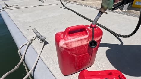 fueling a boat with petrol at the dock