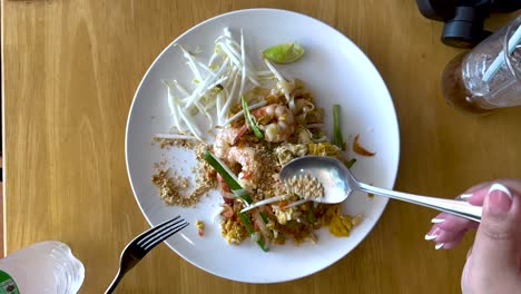 savoring a delicious pad thai dish